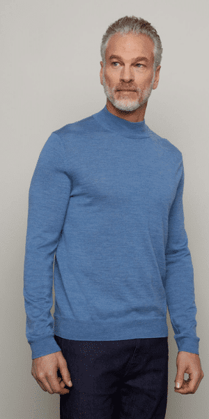 model in blue mock neck jumper