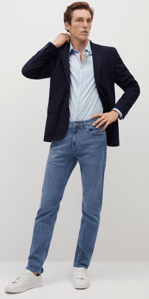 model wearing navy blazer and jeans