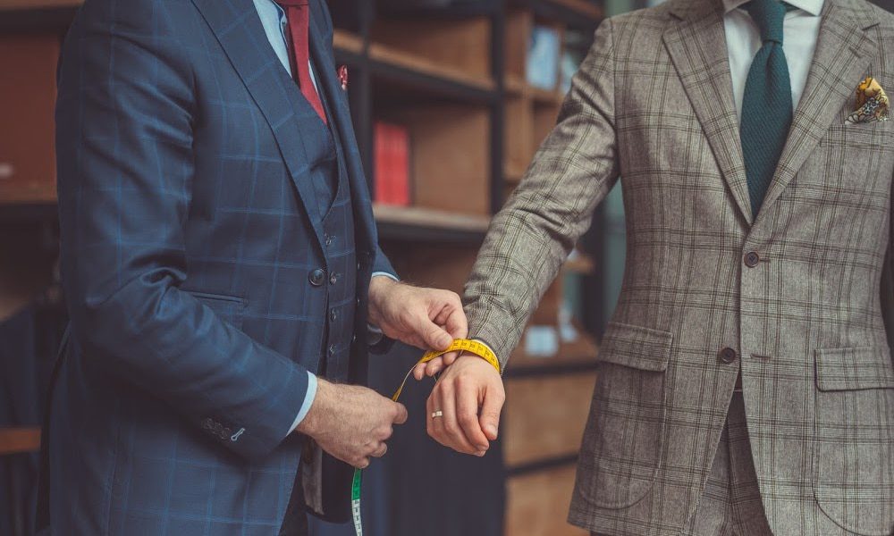 tailor measuring a suit